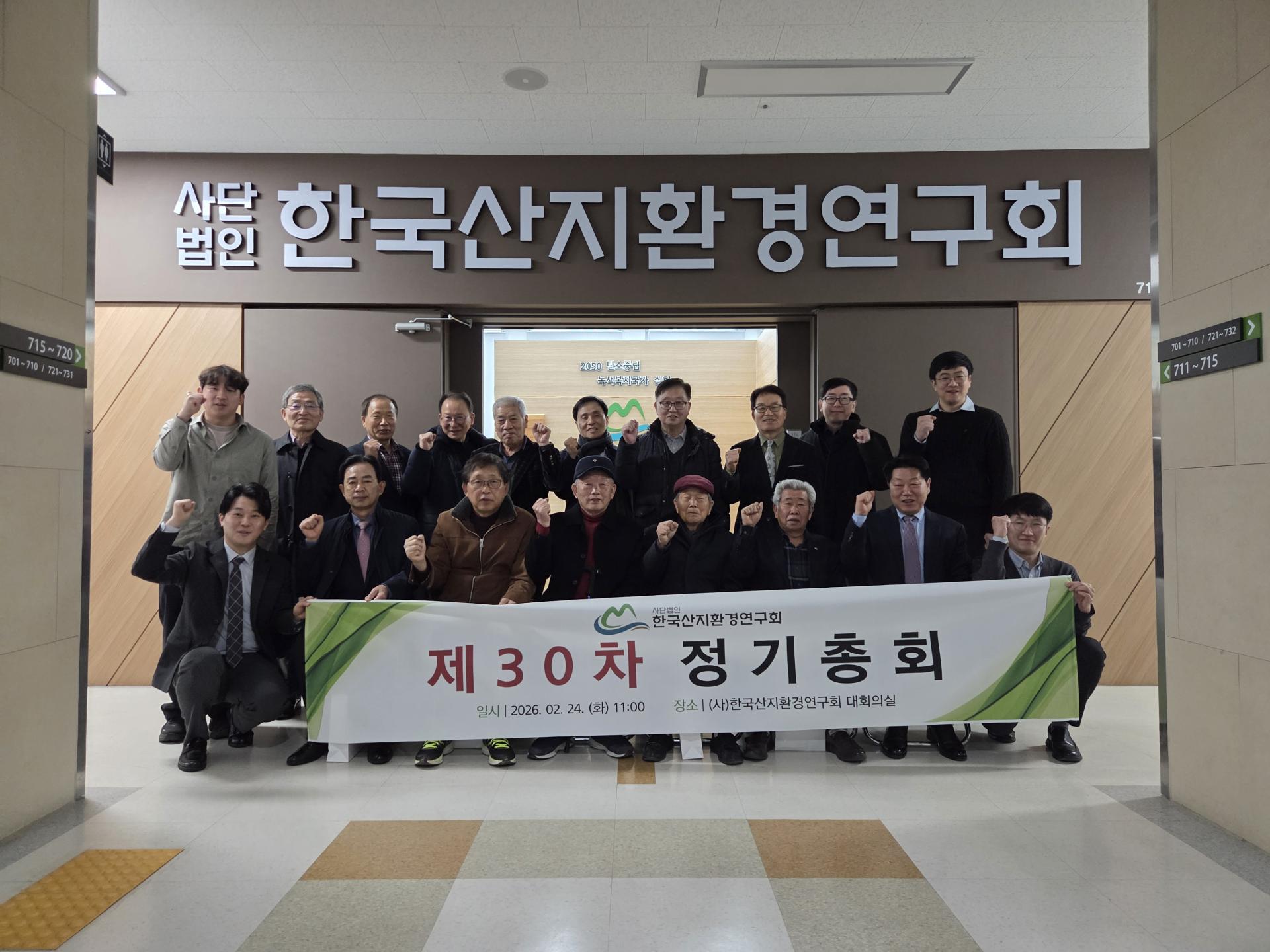 제30차 정기총회 단체 기념: 회원들이 주먹을 들어 올리며 함께 기념하는 모습